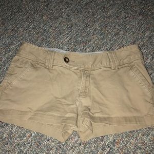 Tan red camel shorts.